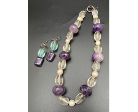 An amethyst, rock Crystal and freshwater pearl necklace with silver T Bar clasp. Together with a pair of amethyst and blue st