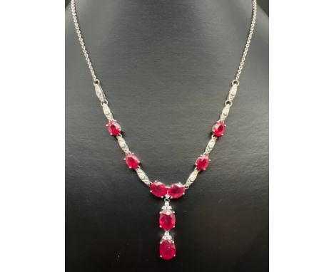 A silver ruby and white topaz fixed drop pendant necklace with spring ring clasp, by The Genuine Gem Company. Set with eight 