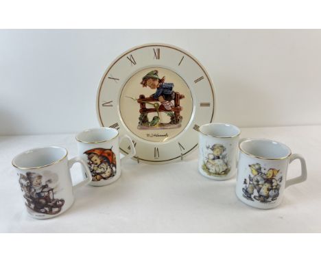 A ceramic M. J. Hummel wall clock with gilt detail together with a set of 4 Hummel mugs by Reutter Porzellan. 