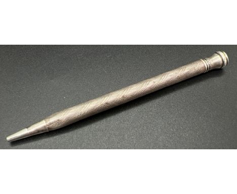 A vintage sterling silver propelling pencil with engine turned decoration to main body. Approx. 9cm long, total weight approx