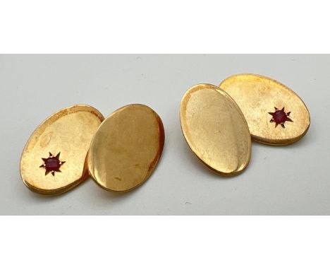 A pair of vintage 9ct gold plain oval cufflinks set with a small ruby to each, by Britannic. Name and gold mark to backs. Tot