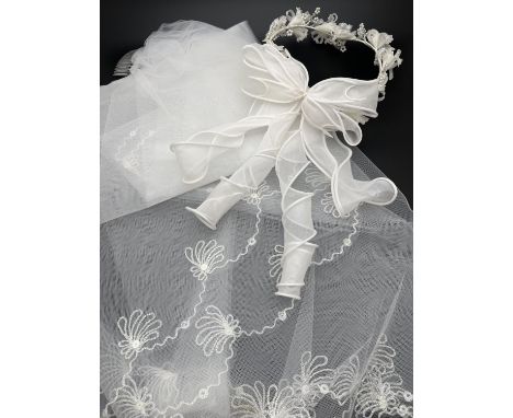 A boxed vintage Pronuptia floral bridal headdress with spiral bow detail to back. Together with a wedding veil with embroider