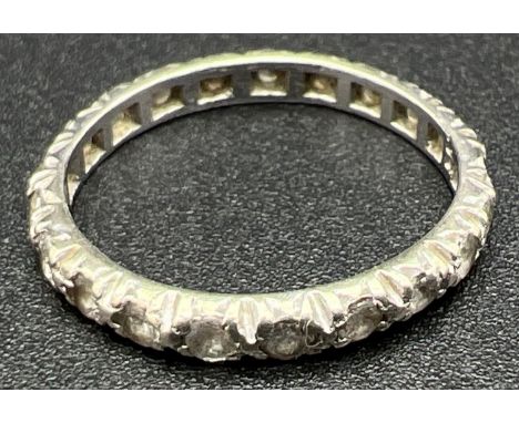 A vintage 9ct white gold full eternity ring set with small round cut clear stones. Gold mark inside of band. Size M½. Total w