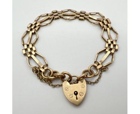 A 9ct gold vintage 3 bar gate style bracelet with padlock clasp and safety chain. Gold marks to back of padlock and fixings. 