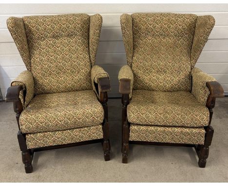 A pair of vintage 1930's dark oak framed wing back chairs with floral design upholstery and turned front legs. Each approx. 9