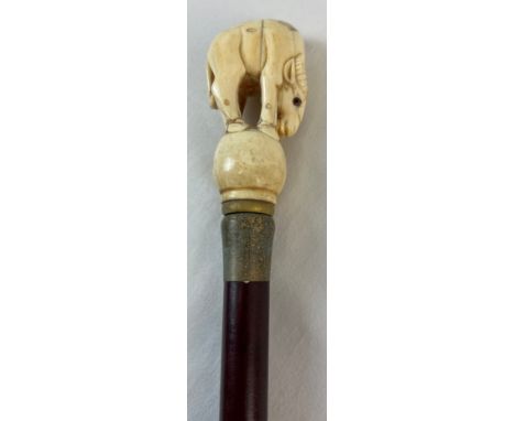 A bone topped walking stick with screw top finial carved in the form of a buffalo. Approx. 90cm long. 