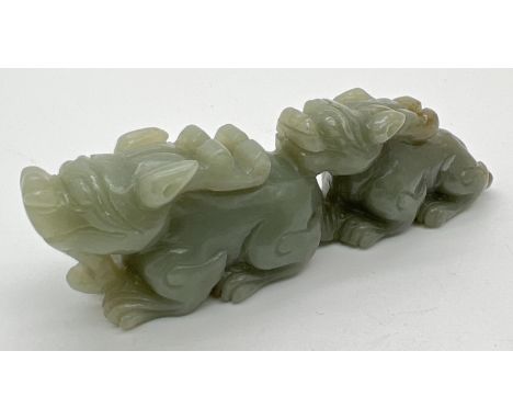 A small piece of Chinese carved green jade modelled as Foo dogs. Approx. 3cm tall x 10cm long. 