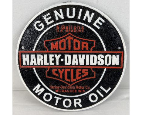 A Harley Davidson Motor Oil circular shaped painted cast iron wall plaque. In black, white and red and with holes for fixing.