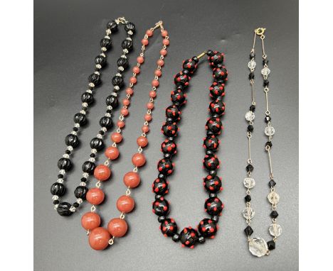 4 vintage glass bead necklaces in varying lengths. To include a 14 inch blue and red art glass bead necklace with barrel push