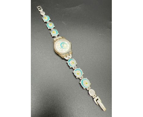 A 2005 Swatch watch #809, with enamel blue and green circle detail bracelet strap. Brushed silver face with same circle desig