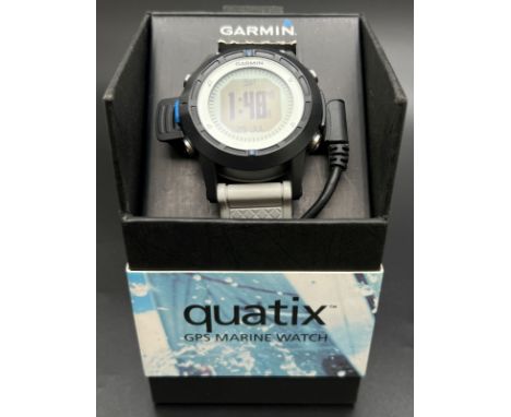A boxed Garmin Quatix GPS Marine watch with leads. Grey silicone strap with black case and digital display. Working order. 