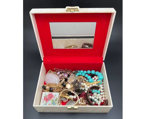 A large vintage cream coloured jewellery box and contents to include gold tone and beaded jewellery items. 