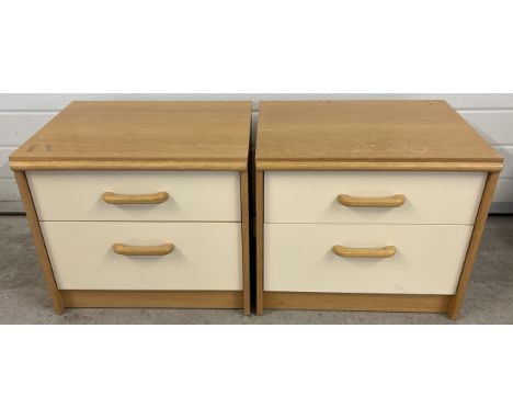 A pair of vintage Stag 2 drawer bedside cabinets in light natural wood and cream coloured finish. Each approx. 46.5cm tall x 