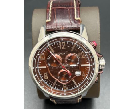 A men's chronograph NY-1324 wristwatch by DKNY. Metallic brown and stainless steel case and face with silver tone hour marker
