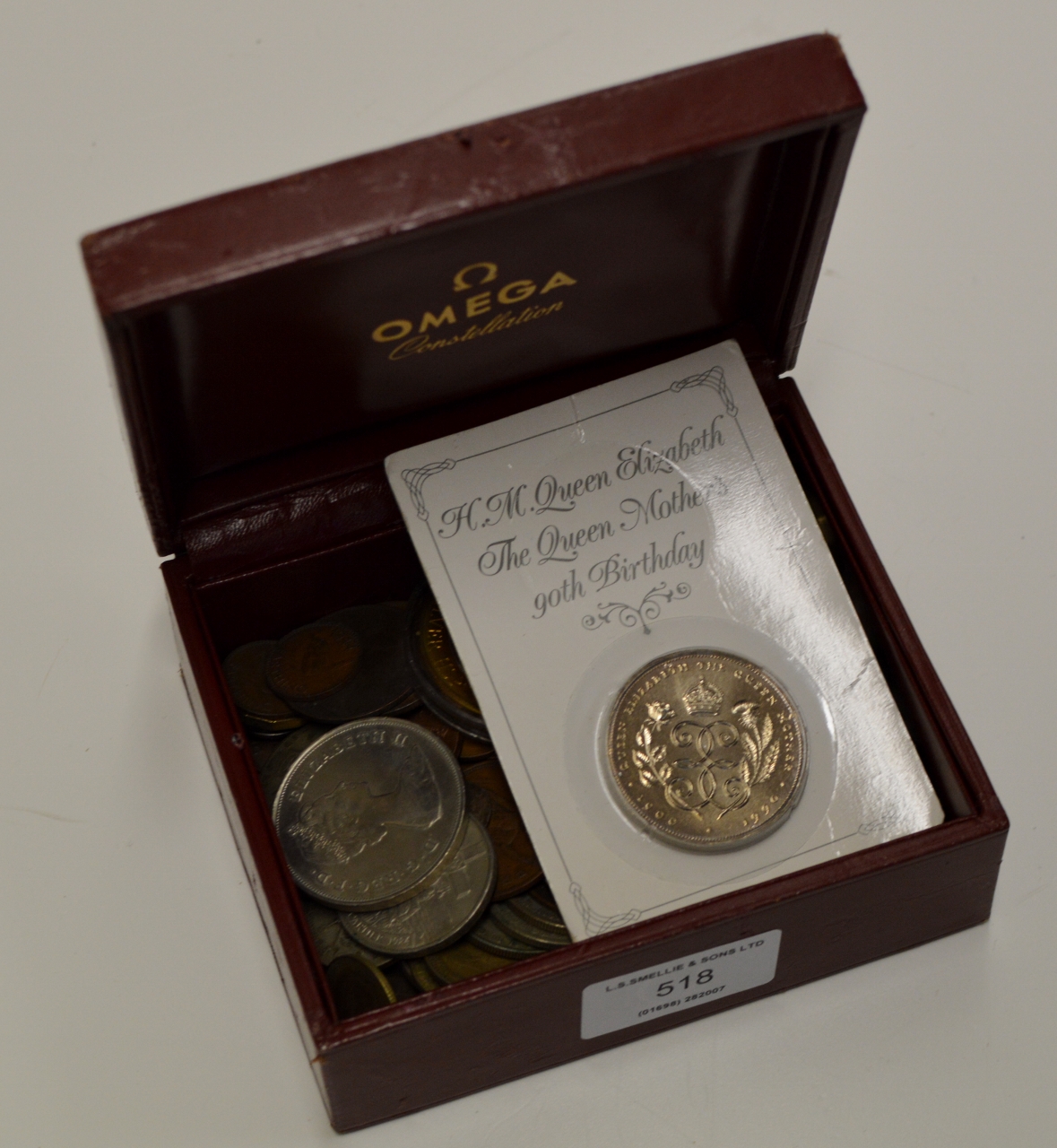 omega-watch-box-with-assorted-coinage