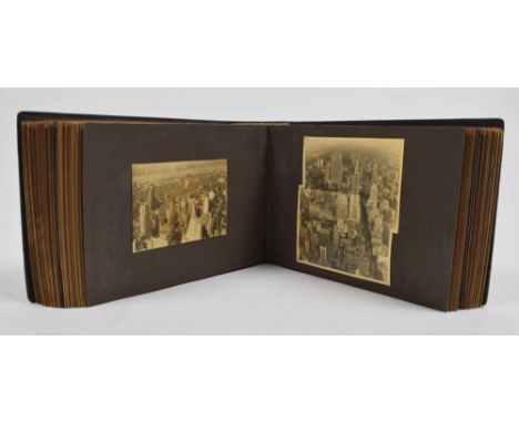 Large leather obl. album (25 x 37 cm) w. approx. 350 b/w tipped-in photos (incl. some reproductions). Manuscript title on spi