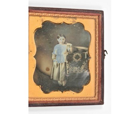 One of a man, the other one of a girl. Both daguerretypes or ambrotypes, 8 x 7 cm, under gilt dec. brass-lamella passepartout