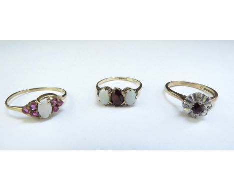 Three 9ct gold rings including opal and garnet, opal and ruby and diamond and red stone examples, 5.3g 