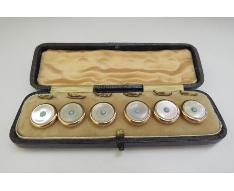 A set of turquoise and mother-of-pearl shirt studs, in fitted case 