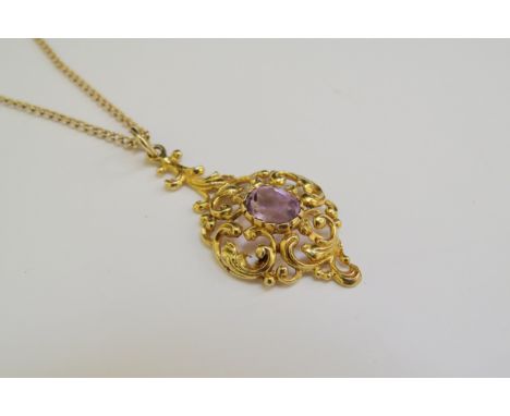 A 9ct gold chain 62cm long, hung with a scrolled foliate pendant with central amethyst, 4cm drop, 8.5g 