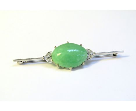 A white gold bar brooch set centrally with a jade cabochon flanked by two diamond set leaves, stamped 18ct, white gold, 6cm l