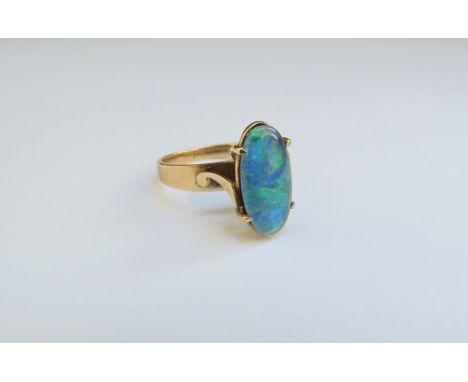 A gold oval opal ring, etched 9c. Size J/K, 2.6g 