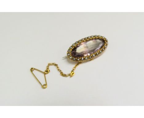 An amethyst and seed pearl brooch of oblong form, stamped 15ct, 3cm long, 5.3g 