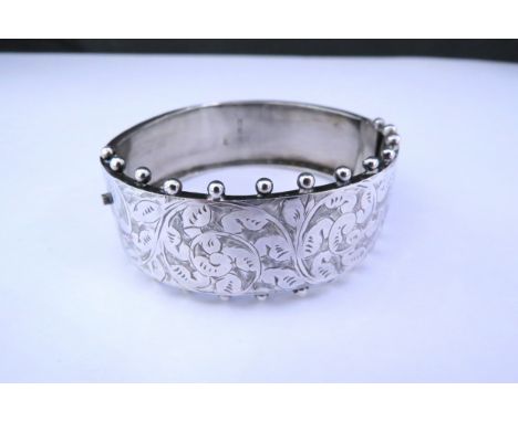 A silver engraved stiff hinge bangle15.9g 