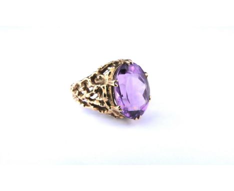 A 9ct gold openwork textured ring with a large oval amethyst. Size P, 6.1g 