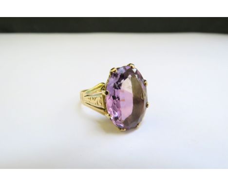 A gold ring set with an oval amethyst. Size P/Q, 5.9g 