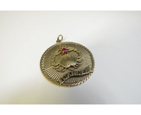A 9ct gold sign of the Zodiac pendant "Cancer" set with a single ruby, 10.7g 