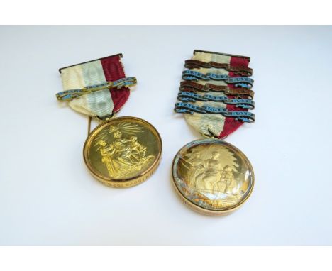 Two silver gilt Masonic medals in glass capsules one with a 15ct gold mount the other 9ct gold, on ribbons 