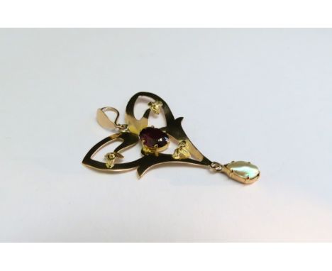 An Edwardian gold pendant with garnet and pearl drop, stamped 9ct, 106g 