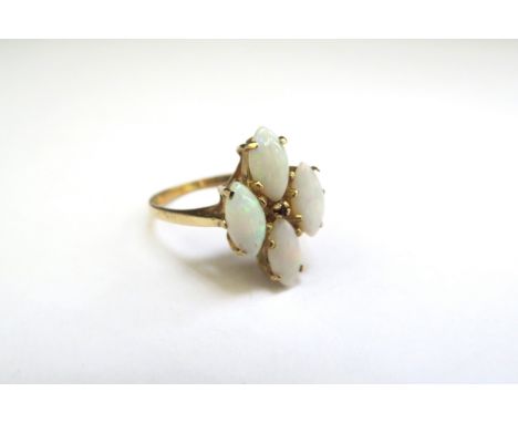 A 9ct gold four stone opal and small ruby set ring. Size M, 2.7g 