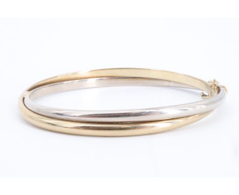 A 9 ct two colour double-hoop bangle, 6 cm x 5.5 cm internally, 12 g