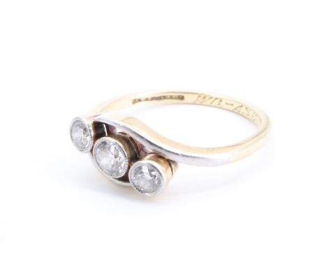 A vintage three stone diamond crossover ring, the three collet set brilliants (approximately 0.35 carat aggregate weight) in 