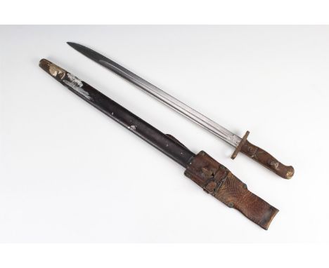 A Pattern 1907 bayonet by Wilkinson, manufactured in 1917, its grips crudely carved, the scabbard fitted with a Pattern 1914 