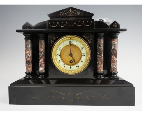 A Victorian marble mantle clock, having a drum movement in an architectural black marble case, the recessed white dial flanke