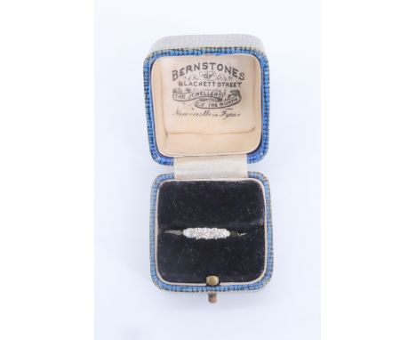 A 1920s five stone diamond ring, comprising five graduated brilliants (approximate aggregate weight 0.2 carat), line set on a