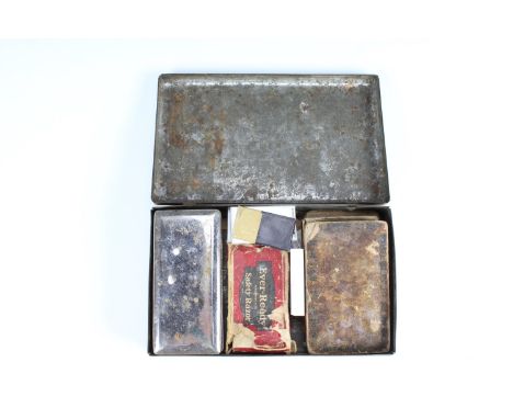 Two vintage safety razors and a Valet autostrop sharpener, in a Co-operative Wholesale Society tinplate biscuits tin