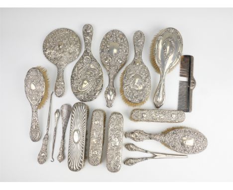 A group of early 20th Century silver bound dressing accessories, including hand mirrors, brushes, glove stretchers, button ho