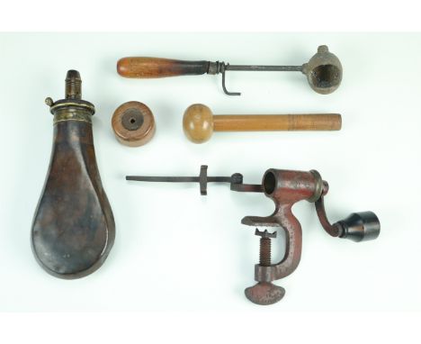 A group of Victorian gun tools and accessories including a Sykes patent powder flask, a 12-bore cartridge turnover tool, a le