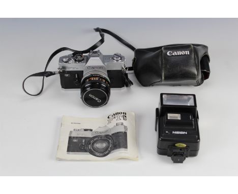 A Canon FTb camera, 50mm lens, together with instruction booklet, and a Nissin flash