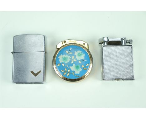 Three vintage cigarette lighters, comprising a Parker "The Roller Beacon" petrol lighter, an engraved and enamelled Zenith, a