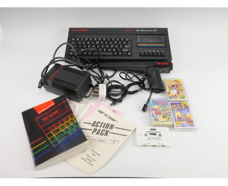 A Sinclair ZX Spectrum +2 home computer, together with a Sinclair light gun, power supply unit, instruction manual and "Kwik 