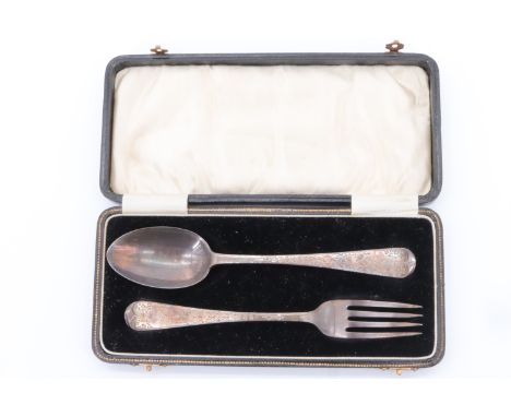 A Victorian cased silver christening set, comprising a Hanoverian pattern spoon and a fork profusely decorated front and back