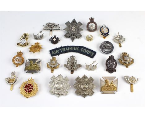 A group of QEII British army cap badges etc