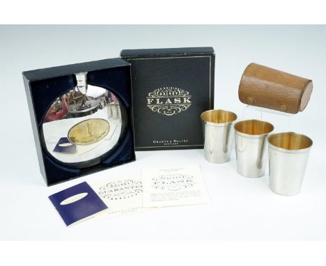 A boxed Grants of Dalvey hip flask, incorporating a telescopic cup, together with a toddy set in a pigskin case