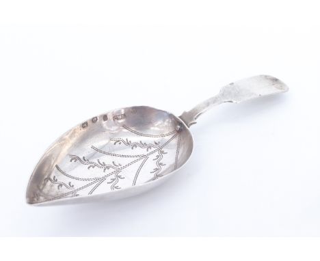 A late 18th / early 19th Century white metal caddy spoon, having an engraved leaf-shaped bowl and fiddle stem, 8 cm, 6.4 g