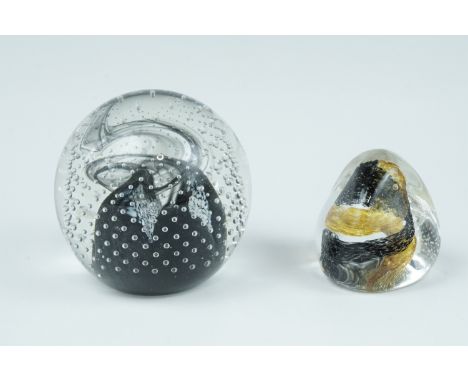 A Caithness "Cauldron" glass paperweight, together with a Caithness "Pebble" paperweight, tallest 8 cm